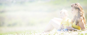A photo of a woman and a baby in a flower field